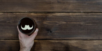 Man's,Hand,Holds,A,Mug,Of,Beer,With,Silhouettes,Of